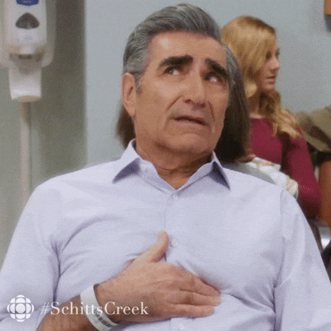 Eugene Levy rubbing his breastbone.