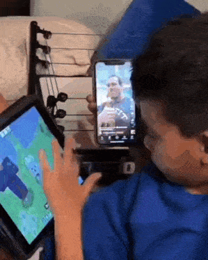 a kid using an ipad and a smartphone at the same time