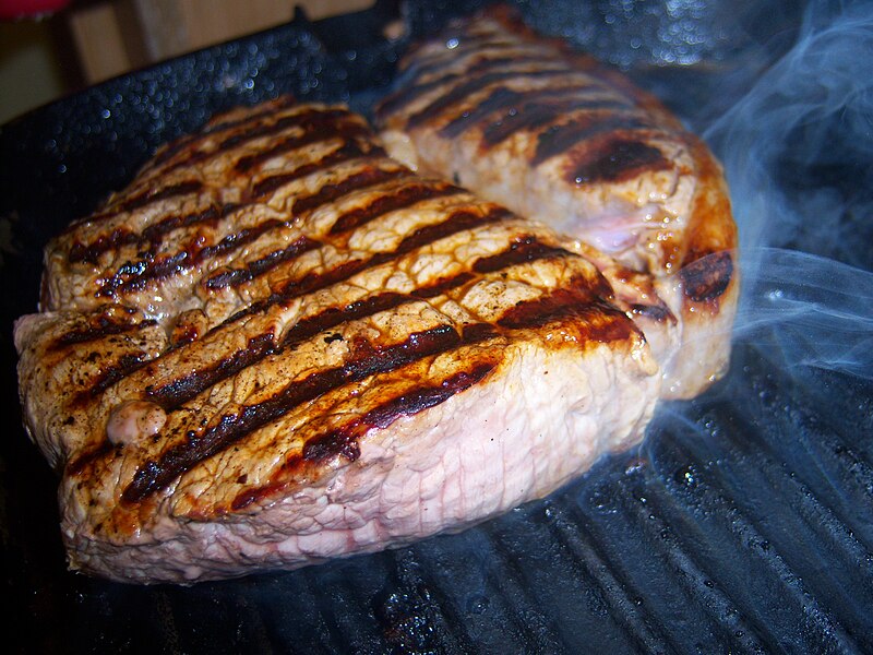 A rump steak on a griddle