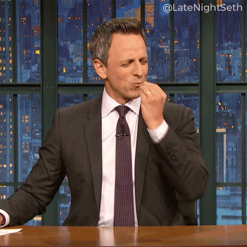 Seth Meyers doing a chef's kiss.