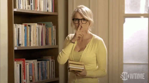 A librarian putting her finger to her lips and saying "shhhh"