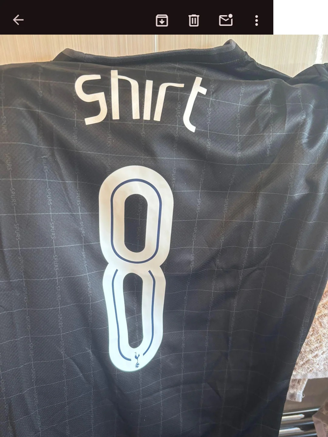 The bac of a football shirt with 'shirt 8' on it