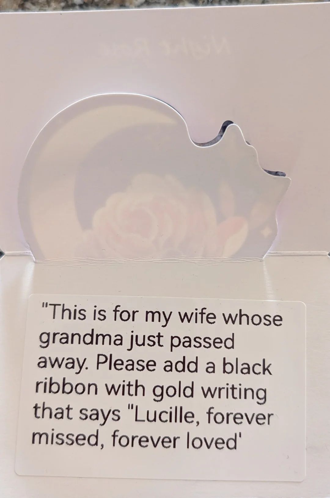 A memorial card with this text - '"This is for my wife whose grandma just passed away. Please add a black ribbon with gold writing that says "Lucille, forever missed, forever loved'