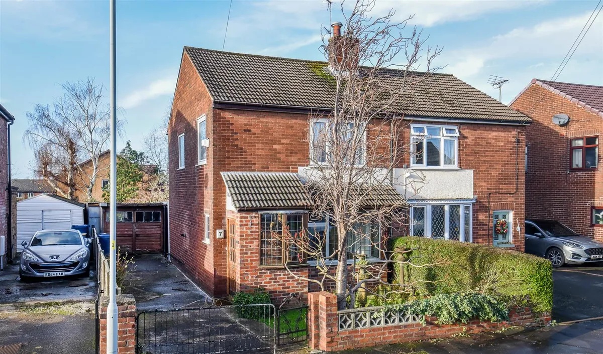 A nice semi-detached house with a small tree in the front garden