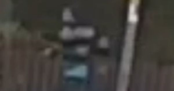 A blurry picture of a man running on a darkened street.