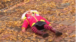 a little girl having a tantrum on a leafy floor