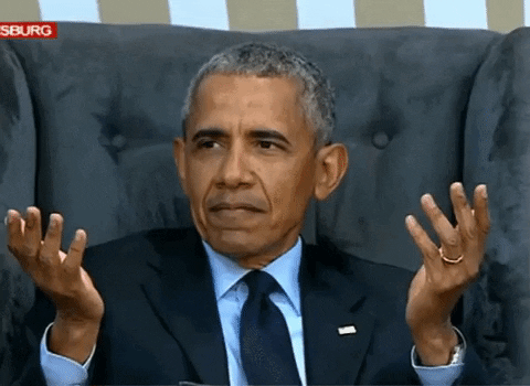 Barack Obama holding up his hands in a questioning gesture.