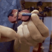 someone playing a tiny violin